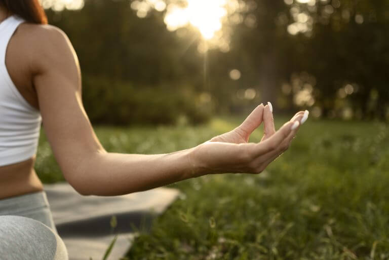 front view woman meditating nature
